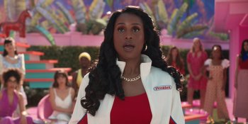 Movie still from “Barbie” (2023), directed by Greta Gerwig – A woman in a red dress and a white jacket; Close Up shot, Over the shoulder angle
