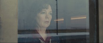 Movie still from “Empire of Light” (2022), directed by Sam Mendes – A woman looking out of a train window; Close Up shot, Over the shoulder angle