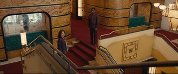 Movie still from “Empire of Light” (2022), directed by Sam Mendes – A man and a woman are standing on the stairs of a building; Extreme Wide shot, High angle