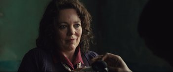 Movie still from “Empire of Light” (2022), directed by Sam Mendes – A person holding a microphone; Close Up shot, Over the shoulder angle