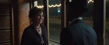 Movie still from “Empire of Light” (2022), directed by Sam Mendes – A woman standing in front of a man in front of a window; Medium shot, Over the shoulder angle