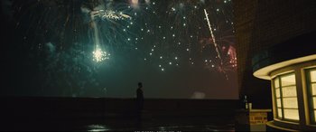 Movie still from “Empire of Light” (2022), directed by Sam Mendes – A person standing in front of a fireworks display; Extreme Wide shot, Low angle