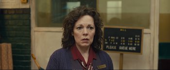 Movie still from “Empire of Light” (2022), directed by Sam Mendes – A woman with curly brown hair wearing a red shirt; Close Up shot, Over the shoulder angle