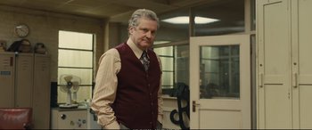 Movie still from “Empire of Light” (2022), directed by Sam Mendes – An older man standing in front of a door; Medium shot, Over the shoulder angle