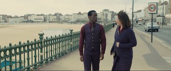 Movie still from “Empire of Light” (2022), directed by Sam Mendes – A man and a woman walking on a bridge; Medium shot, Over the shoulder angle