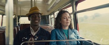 Movie still from “Empire of Light” (2022), directed by Sam Mendes – A man and a woman riding on a bus; Medium shot, Over the shoulder angle