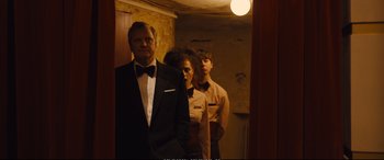 Movie still from “Empire of Light” (2022), directed by Sam Mendes – A man and two women standing in front of a mirror; Medium shot, Over the shoulder angle