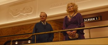 Movie still from “Empire of Light” (2022), directed by Sam Mendes – A man and a woman standing next to a railing; Medium shot, Low angle