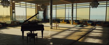 Movie still from “Empire of Light” (2022), directed by Sam Mendes – A room filled with furniture next to a window; Extreme Wide shot, High angle