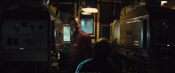 Movie still from “Empire of Light” (2022), directed by Sam Mendes – A man standing next to a woman in a room; Medium shot, Over the shoulder angle