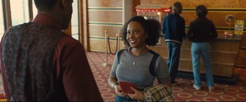 Movie still from “Empire of Light” (2022), directed by Sam Mendes – A woman holding a cell phone in her hands; Medium shot, Over the shoulder angle