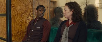 Movie still from “Empire of Light” (2022), directed by Sam Mendes – A man and a woman sitting next to each other; Medium shot, Over the shoulder angle