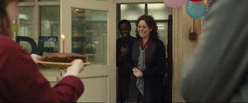 Movie still from “Empire of Light” (2022), directed by Sam Mendes – A woman standing in front of a door with a man standing next to her; Medium shot, Over the shoulder angle