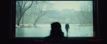 Movie still from “Empire of Light” (2022), directed by Sam Mendes – A man walking in the water with a cane; Extreme Wide shot, Over the shoulder angle