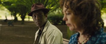 Movie still from “Empire of Light” (2022), directed by Sam Mendes – A man wearing a brown hat sitting next to a woman wearing a brown hat; Close Up shot, Over the shoulder angle