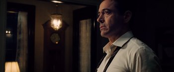 Movie still from “The Judge” (2014), directed by David Dobkin – A person standing in a room near a clock; Close Up shot, Low angle