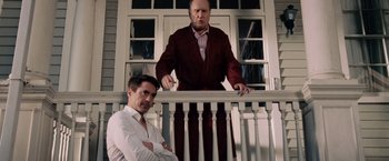 Movie still from “The Judge” (2014), directed by David Dobkin – Two men standing on a porch railing; Medium shot, Low angle