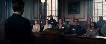 Movie still from “The Judge” (2014), directed by David Dobkin – A group of people sitting in front of a podium in a courtroom; Wide shot, High angle