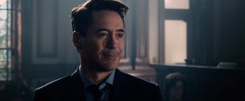 Movie still from “The Judge” (2014), directed by David Dobkin – A person wearing a suit and tie; Close Up shot, Over the shoulder angle