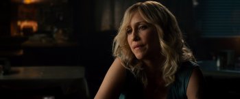 Movie still from “The Judge” (2014), directed by David Dobkin – A woman with blonde curly hair sitting in a room; Close Up shot, Over the shoulder angle