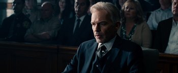 Movie still from “The Judge” (2014), directed by David Dobkin – A man in a suit and tie in a courtroom; Close Up shot, Over the shoulder angle