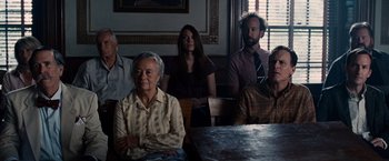 Movie still from “The Judge” (2014), directed by David Dobkin – A group of people sitting around a table; Medium shot, High angle