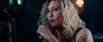 Movie still from “The Judge” (2014), directed by David Dobkin – A woman with blonde curly hair is looking up; Close Up shot, Over the shoulder angle