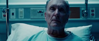 Movie still from “The Judge” (2014), directed by David Dobkin – An older man is sitting in a hospital bed; Close Up shot, Low angle