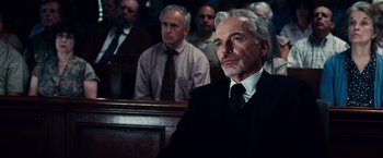 Movie still from “The Judge” (2014), directed by David Dobkin – An older man sitting in front of a group of people; Close Up shot, Low angle