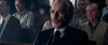 Movie still from “The Judge” (2014), directed by David Dobkin – An older man in a suit and tie looking into the distance; Close Up shot, Over the shoulder angle