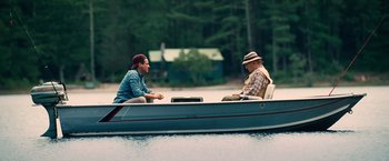 Movie still from “The Judge” (2014), directed by David Dobkin – Two men sitting in a boat on the water; Wide shot, Over the shoulder angle