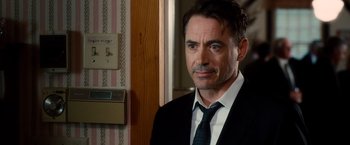 Movie still from “The Judge” (2014), directed by David Dobkin – A person wearing a suit and tie; Close Up shot, Over the shoulder angle