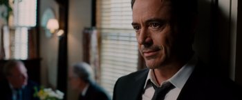 Movie still from “The Judge” (2014), directed by David Dobkin – A person wearing a suit and tie; Close Up shot, Over the shoulder angle