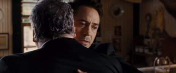 Movie still from “The Judge” (2014), directed by David Dobkin – A man hugging another man in a room; Close Up shot, Over the shoulder angle