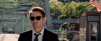 Movie still from “The Judge” (2014), directed by David Dobkin – A person wearing a suit and sunglasses; Close Up shot, Over the shoulder angle