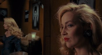 Movie still from “Batman” (1989), directed by Tim Burton – A woman with blonde hair and red lipstick looking to her left; Close Up shot, Over the shoulder angle