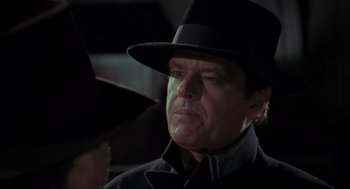 Movie still from “Batman” (1989), directed by Tim Burton – A person wearing a hat; Close Up shot, Over the shoulder angle