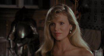 Movie still from “Batman” (1989), directed by Tim Burton – A woman with long blonde hair wearing a strapless top; Close Up shot, Over the shoulder angle