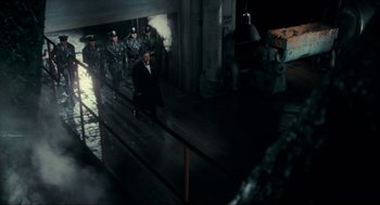 Movie still from “Batman” (1989), directed by Tim Burton – A group of men standing next to a railing; Wide shot, High angle