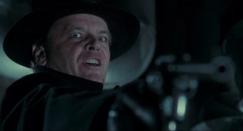 Movie still from “Batman” (1989), directed by Tim Burton – A person wearing a hat; Close Up shot, Over the shoulder angle