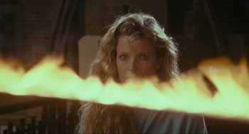 Movie still from “Batman” (1989), directed by Tim Burton – A woman with long blonde curly hair looking at the camera; Close Up shot, Low angle