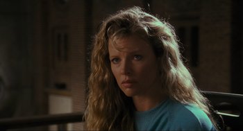 Movie still from “Batman” (1989), directed by Tim Burton – A person with long blonde hair; Close Up shot, Over the shoulder angle