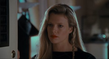 Movie still from “Batman” (1989), directed by Tim Burton – A woman with long blonde hair and orange lipstick; Close Up shot, Low angle