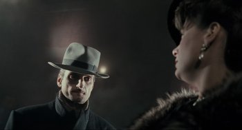 Movie still from “Batman” (1989), directed by Tim Burton – A man and a woman wearing hats and coats; Close Up shot, Over the shoulder angle