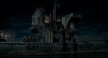 Movie still from “Batman” (1989), directed by Tim Burton – An industrial building is shown in the dark sky; Extreme Wide shot, High angle