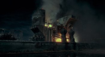 Movie still from “Batman” (1989), directed by Tim Burton – An industrial building is burning in the dark; Extreme Wide shot, Low angle