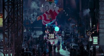 Movie still from “Batman” (1989), directed by Tim Burton – A parade float is shown in the middle of a crowd; Extreme Wide shot, High angle