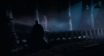 Movie still from “Batman” (1989), directed by Tim Burton – A dark room with a batman costume on the floor; Extreme Wide shot, High angle