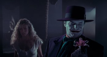Movie still from “Batman” (1989), directed by Tim Burton – A man in a purple suit and a woman in a white dress; Close Up shot, Over the shoulder angle