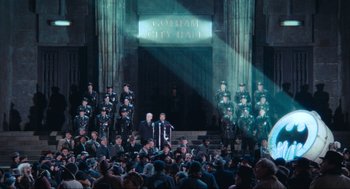 Movie still from “Batman” (1989), directed by Tim Burton – A group of men standing in front of a building; Extreme Wide shot, High angle